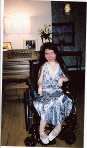 Photograph of a smiling Shirley Cheng, a blind and physically disabled motivational speaker, poet, author of nine books and contributing author of seventeen, and advocate of parental rights in children's medical care and students with special needs